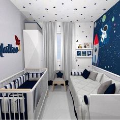 a baby's room decorated in blue, white and grey with stars on the ceiling