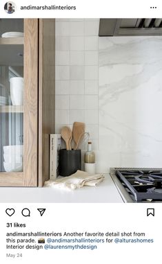 a stove top oven sitting inside of a kitchen next to a wooden cabinet and counter