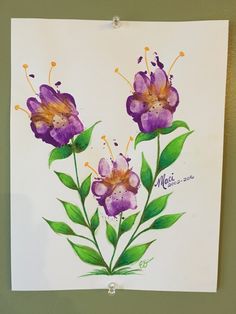 a painting of purple flowers with green leaves on a white paper hanging on a wall