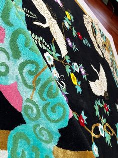 a black blanket with colorful designs on it