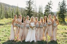 a group of women standing next to each other on top of a grass covered field