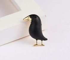 a small black bird sitting on top of a white table