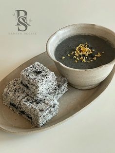 a bowl of soup and two pieces of cake on a plate