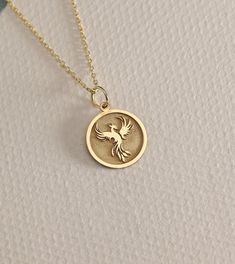 14K Real Solid Gold phoenix gold necklace ● Material of pendant: Solid Gold 14k ( REAL GOLD ) ● Metal Stamp: 14L ( REAL GOLD ) ● The pendant is available in 6 sizes: - 14,0 mm / 0,55 inches ( Diameter ) In the photos - 15,3 mm / 0.60 inches ( Diameter ) - 16,5 mm / 0,65 inches ( Diameter ) - 19,1 mm / 0,75 inches ( Diameter ) - 21 mm / 0,82 inches ( Diameter ) - 23 mm / 0.90 inches ( Diameter ) ( In the photos the size is 14mm / 0.55 inches Diameter ) ( Jump Ring inner diameter: 4 mm ) ● Materia Phoenix Bird, Bird Pendant, Bird Necklace, Amber Stone, We Can Do It, Necklace Personalized, Garnet Rings, Gold Charm, Gold Style