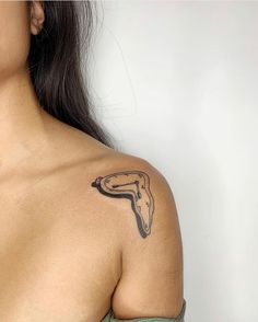 a woman with a tattoo on her shoulder