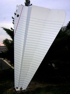 an upside down kite sitting in the grass