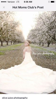 a woman in a white dress is sitting on the ground