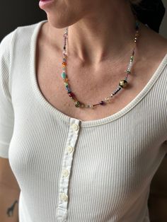 Discover a unique fusion of elements in our Unique Boho Beaded Necklace, a piece that artfully marries the ethereal sparkle of crystals, the soothing energies of rose quartz, and the timeless elegance of pearls. This 22-inch beaded necklace is a testament to creativity and craftsmanship, expertly handcrafted to captivate hearts. Featuring an array of captivating gemstones and glass beads, this necklace is more than an accessory; it's a work of art that invites you to explore its intricate details. Sparkling crystals add a touch of enchantment, illuminating your aura and creating a mesmerizing visual effect. Jade beads, both in its vibrant green and calming purple forms, infuses the necklace with its unique energies. Green jade promotes harmony and balance, while purple jade enhances spirit Artisan Multicolor Necklaces For Wedding, Artisan Multicolor Necklace For Wedding, Spiritual Beaded Necklace With Colorful Beads For Wedding, Bohemian Faceted Beads Necklaces For Weddings, Bohemian Necklaces With Faceted Beads For Wedding, Elegant Multicolor Beaded Necklaces With Spacer Beads, Bohemian Faceted Beads Necklace For Wedding, Multicolor Fusion Beaded Necklace, Fusion Style Colorful Beads Jewelry For Festival