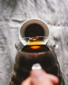 a person holding a wine glass filled with liquid