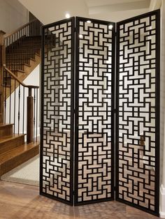 a room divider in the middle of a wooden floor with stairs and railings