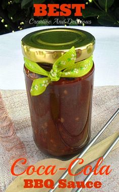 there is a jar of food on the table with spoons and utensils