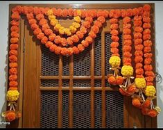 an orange and yellow garland with flowers on it