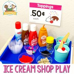 an ice cream shop play table with lots of toppings