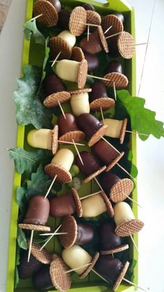 chocolate covered marshmallows and wafer cones are arranged on a green tray