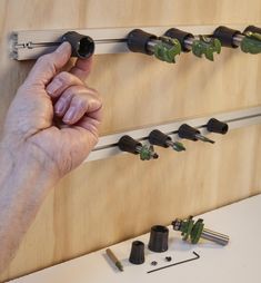 a man is working on a wall mounted tool rack