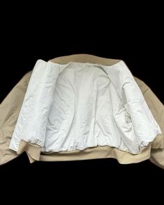 an unmade bed with white sheets and pillows on it's sides, in front of a black background