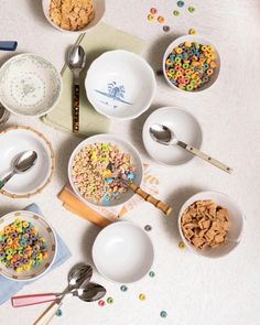 bowls and spoons filled with cereal on a table