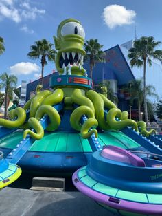 an inflatable water slide with large green octopus on it's back and arms