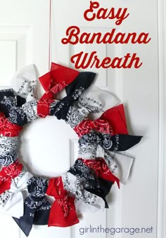 an easy bandana wreath is hanging on the front door with red, white and black ribbons