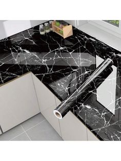 a black and white marble counter top in a kitchen