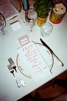 the table is set with silverware and place settings