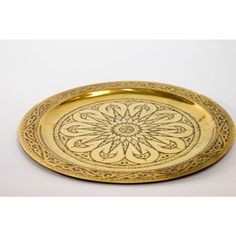 a gold plate with an intricate design on it