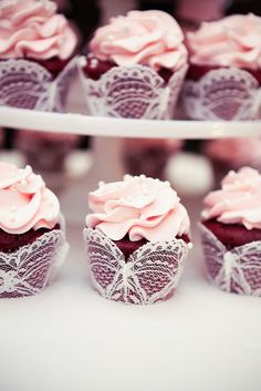 cupcakes with pink frosting and lace on them