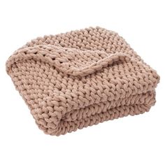 a beige knitted blanket folded on top of each other