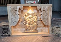 an intricate carved wooden ganesha in the middle of construction