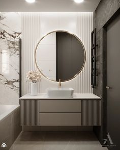 a bathroom with marble walls and flooring, a large round mirror above the sink