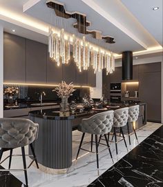 a modern kitchen with black marble counter tops and grey velvet bar stools, surrounded by hanging crystal chandeliers