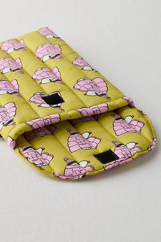 a yellow and pink case with cartoon characters on the front, sitting on a white surface