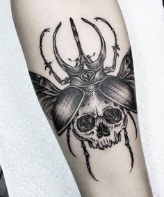 a black and white tattoo with a beetle on it