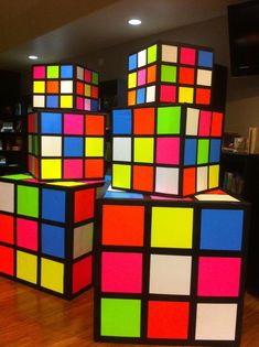 several colorful cubes sitting on top of a hard wood floor