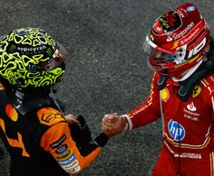 two race drivers shaking hands on the track