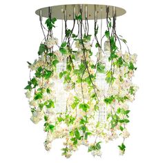 a chandelier with white flowers hanging from it's sides and green leaves