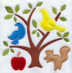 an apple, bird and squirrel applique on a white towel