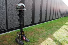 A helmet, rifle, set of dog tags and pair of boots, called a Fallen Soldier Battle Cross, stands in front of the Vietnam War Memorial Wall replica in tribute to those killed in action at the Vietnam Veterans Thank You Veteran, Memorial Wall, Fallen Soldier, Vietnam Veterans Memorial, Veterans Memorial