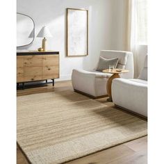 a living room with white furniture and wooden flooring, along with a beige rug