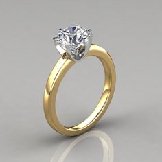 a yellow gold engagement ring with a single diamond in the center, on a gray background