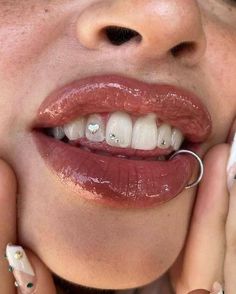 a close up of a woman with her mouth open and nails painted on the outside