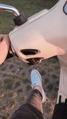 a person is riding a motorcycle with their feet on the handlebars