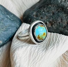 This ring features a beautifully unique bright blue piece of Kingman, AZ Turquoise. The Turquoise is set in a mini shadowbox .925 sterling silver handcrafted design and a hammered band to compliment the Boho style of the ring.  The ring is US size 6-6.25. (Just a bit larger than a true size 6.) IG: @wildrose.silver Please contact me for custom stones and sizing! Collectible Round Turquoise Ring, Handmade Blue Turquoise Ring For Collectors, Collectible Untreated Blue Turquoise Ring, Adjustable Blue Turquoise Ring Collectible, Southwestern Style Blue Nickel-free Rings, Blue Artisan Turquoise Ring Nickel Free, One-of-a-kind Blue Turquoise Ring, One Of A Kind Blue Turquoise Ring, Blue Untreated Round Turquoise Ring