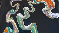 an abstract painting with multicolored lines on black paper