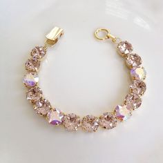 Bracelet featuring 8mm Swarovski pale blush pink and crystal AB crystals set in gold plated metal. Vintage signed Paolo Gucci fold over clasp closure. Also gold plated. 7 1/2 inches in length. Available in gold plated (as shown) or rose gold plated metal. Please choose from drop down menu at check out. Thanks for stopping by! Pink Crystal Bracelet, Light Blush Pink, Inexpensive Jewelry, Swarovski Crystal Bracelet, Bangles Jewelry Designs, Ballet Pink, Fancy Jewellery, Bridesmaid Bracelet, Bridal Bracelet