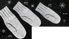 three pairs of socks are shown in this black and white photo with snowflakes