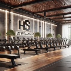 an empty gym with rows of treadmills and benches in front of the wall