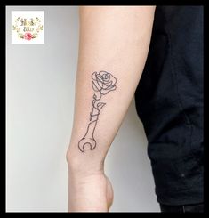 a woman's arm with a rose tattoo on the left side of her arm