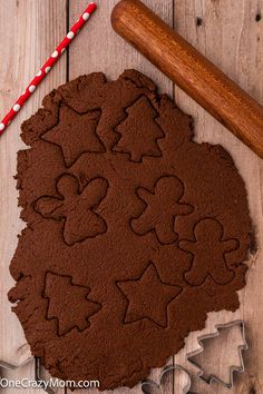 a cookie with chocolate frosting on it next to a rolling pin