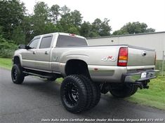 a silver truck parked in front of a building